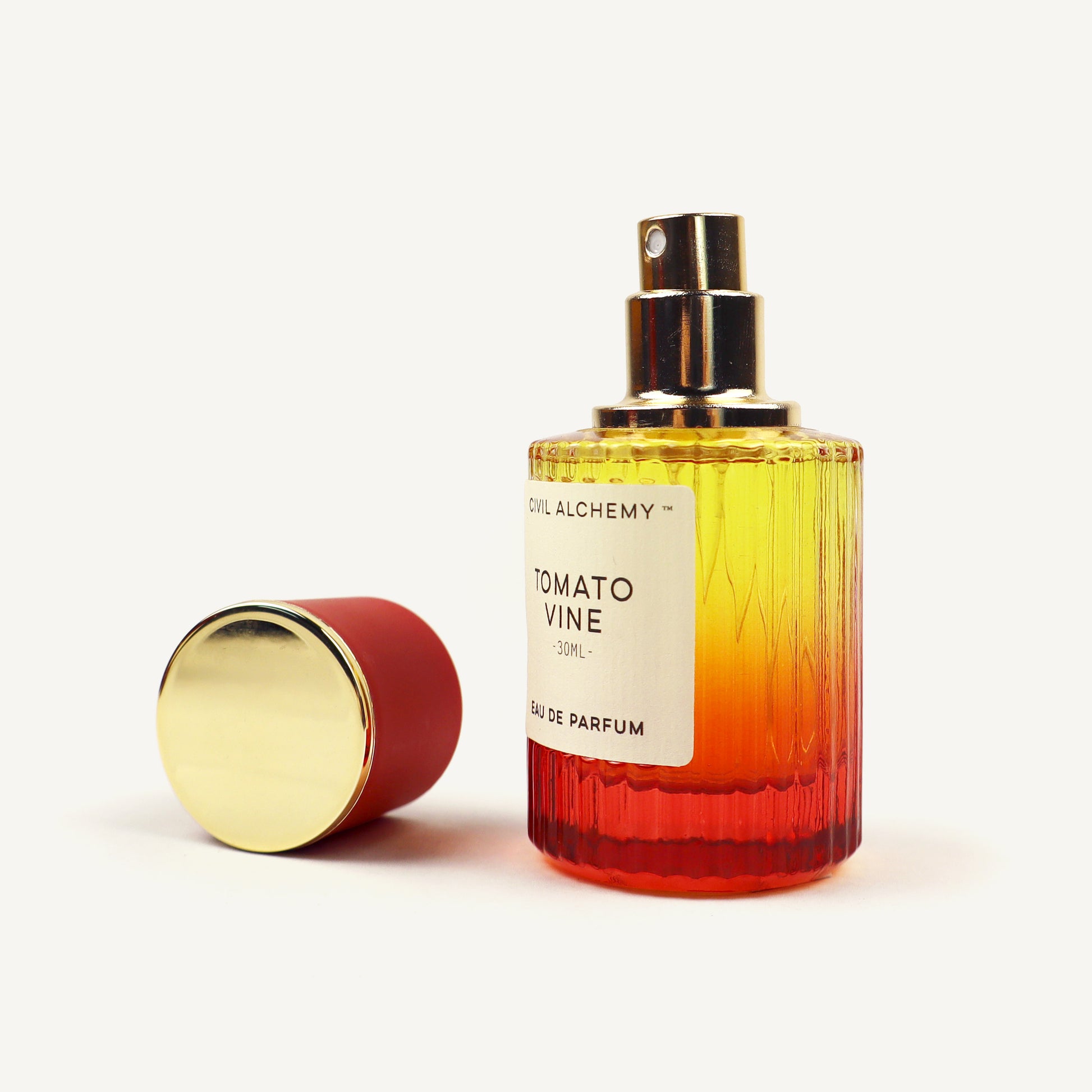 Perfume bottle with gradient design and gold cap on a white background