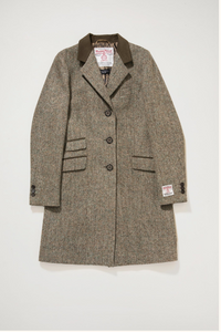 Herringbone patterned coat with brand labels on a white background