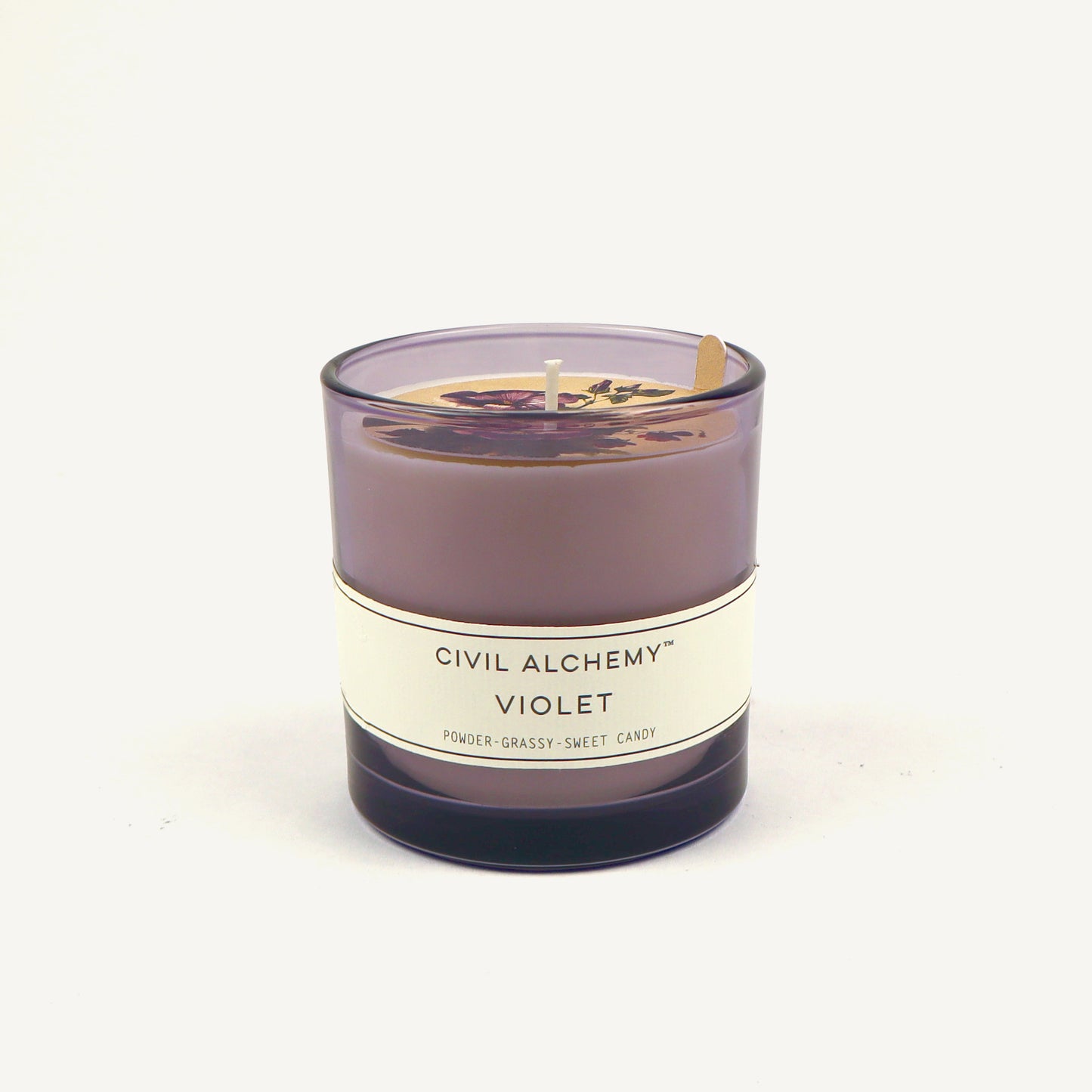 Violet candle with 'Civil Alchemy' label on a white background