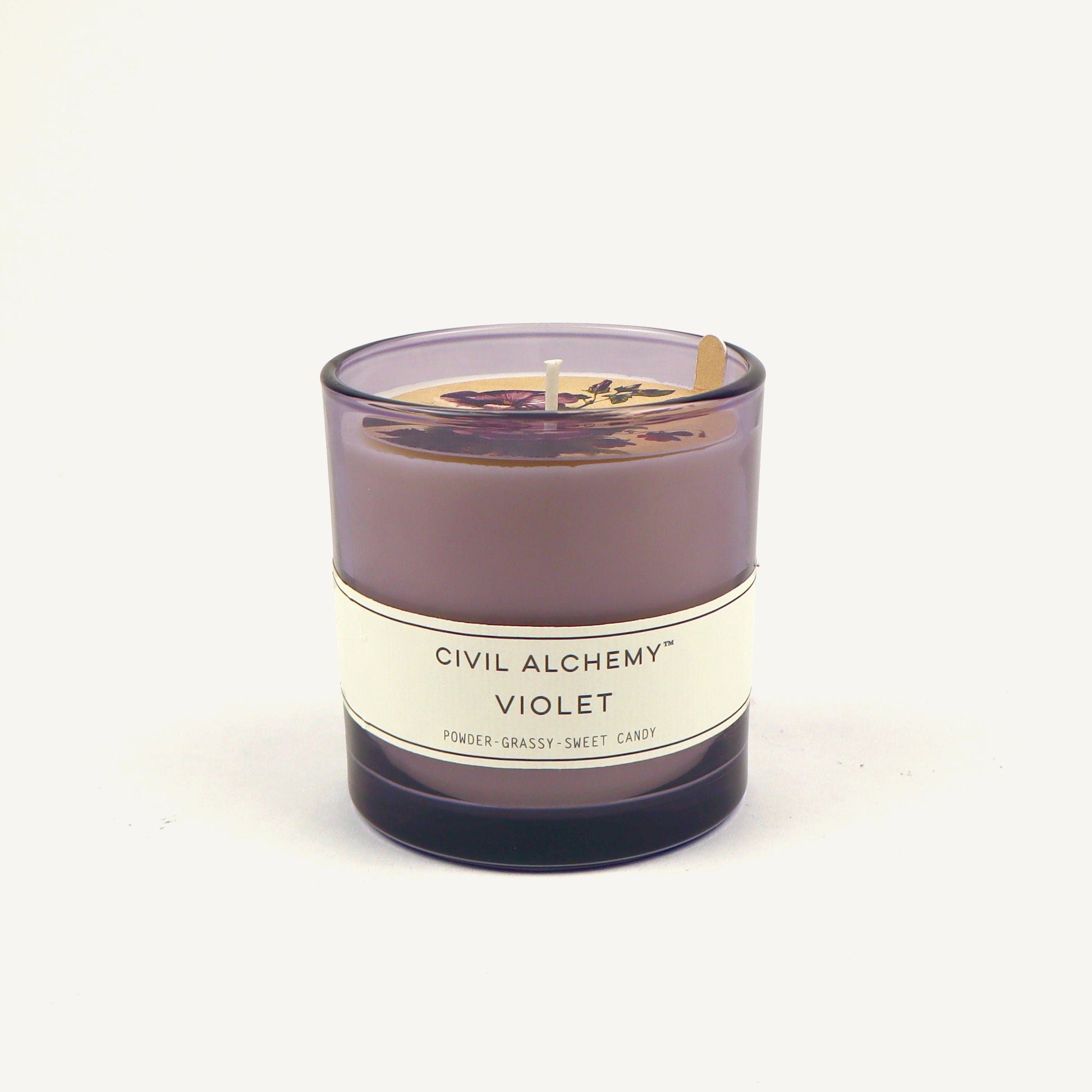 Violet candle with 'Civil Alchemy' label on a white background