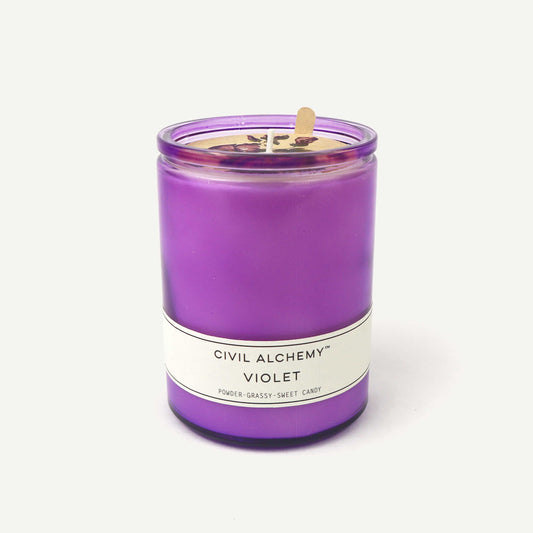 Purple candle with a label on a white background