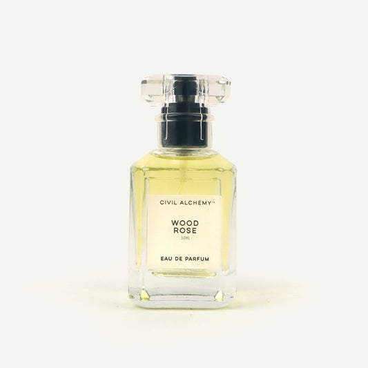 Perfume bottle labeled 'Wood Rose' by Civil Alchemy on a white background