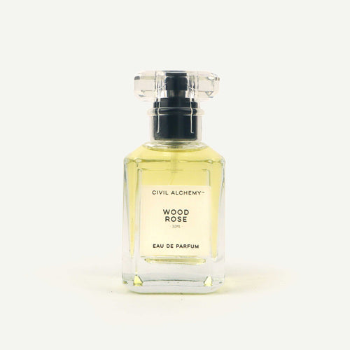 Perfume bottle labeled 'Wood Rose' by Civil Alchemy on a white background