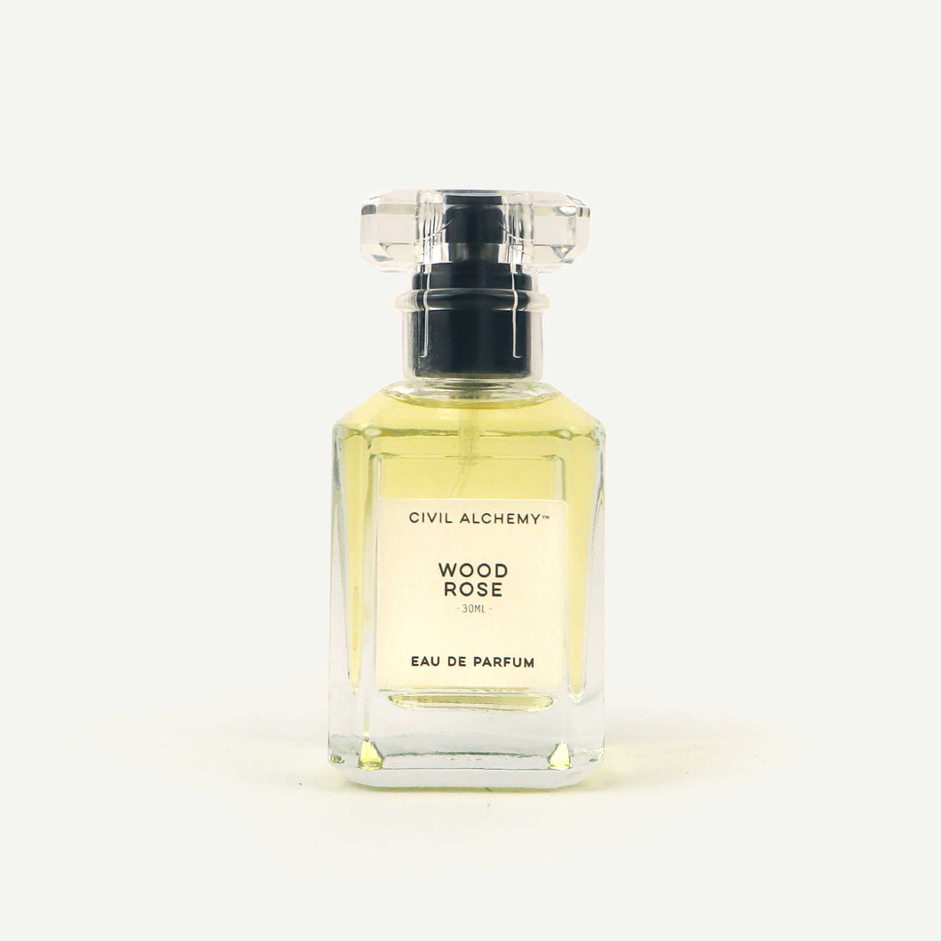 Perfume bottle labeled 'Wood Rose' by Civil Alchemy on a white background