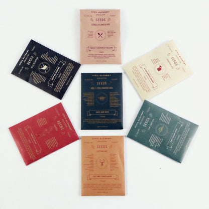 Collection of seed packets with various designs on a white background