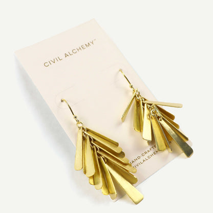 Gold fringe earrings on a Civil Alchemy branded card