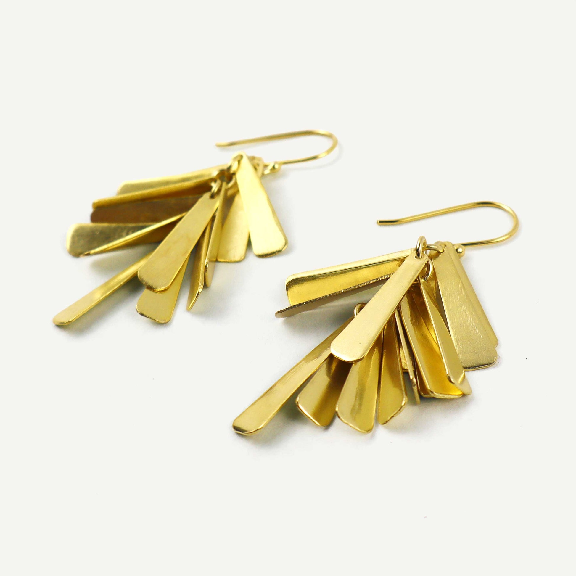 Gold earrings with fan-shaped design on a white background