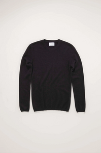 Black sweater on a light beige background