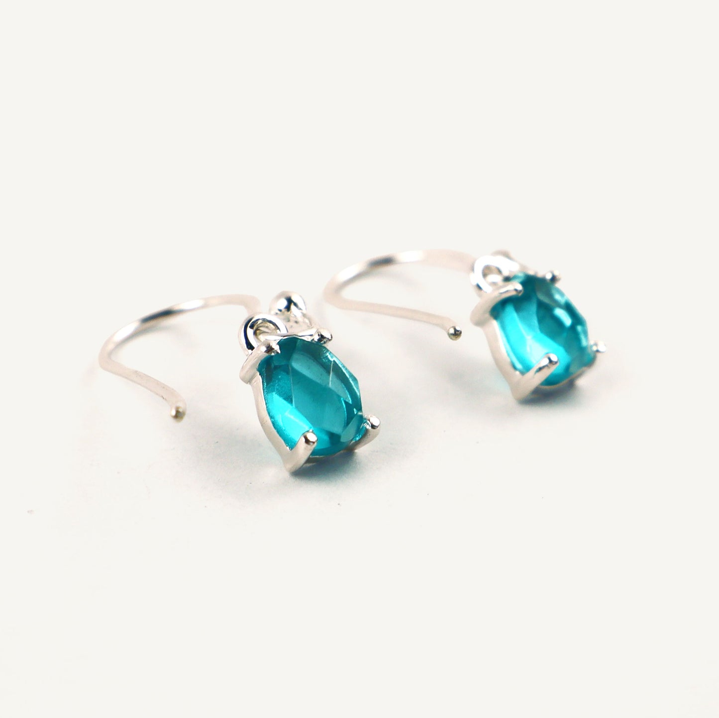 Pair of Blue Apatite teardrop earrings on a white background
