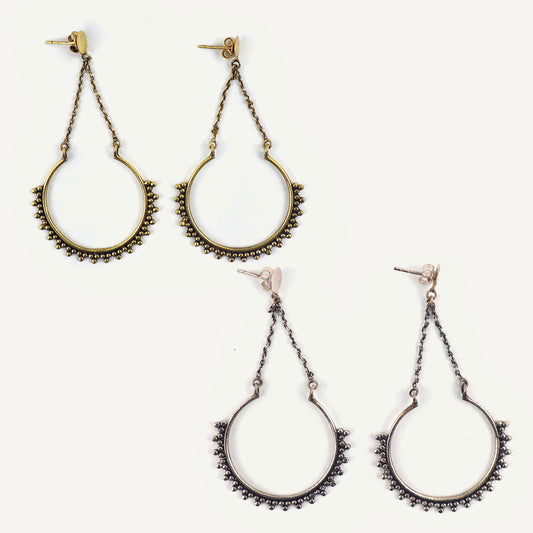 Pair of hoop earrings with chain details on a white background