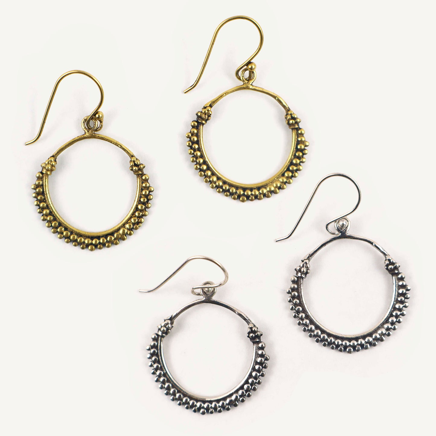 Set of hoop earrings in gold and silver on a white background