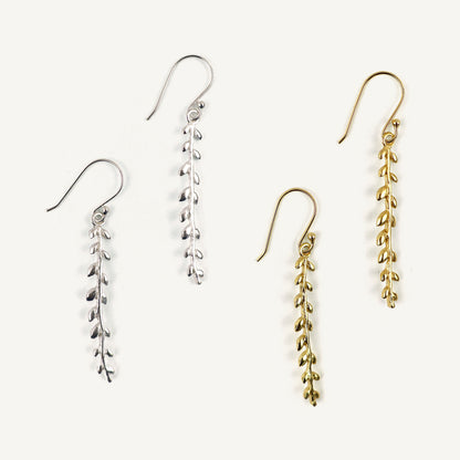 Set of four earrings in silver and gold on a white background