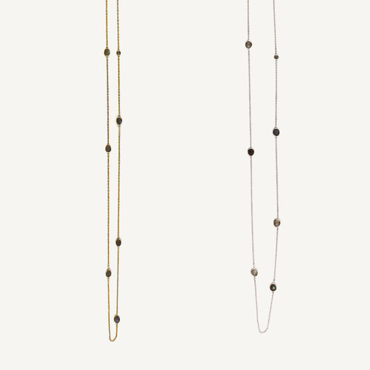 Two long beaded necklaces on a white background