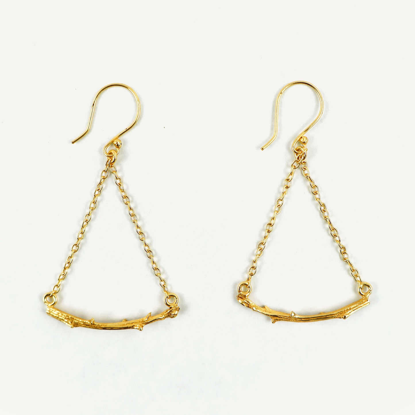 Gold earrings with chain designs on a white background