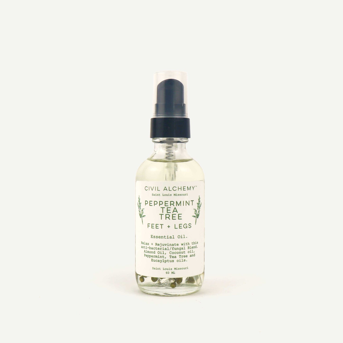 Bottle of Civil Alchemy peppermint tea tree essential oil on a white background