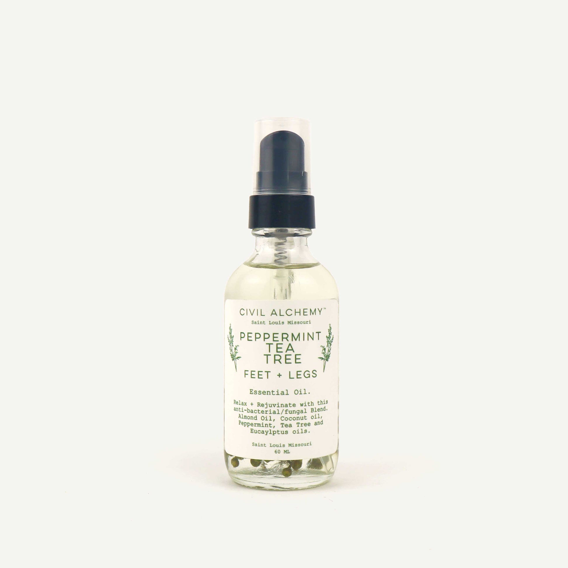 Bottle of Civil Alchemy peppermint tea tree essential oil on a white background