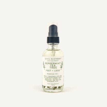 Bottle of Civil Alchemy peppermint tea tree essential oil on a white background
