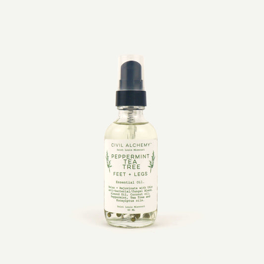Bottle of Civil Alchemy peppermint tea tree essential oil on a white background