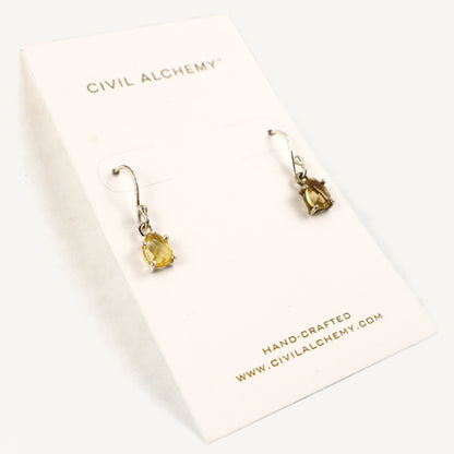 Silver earrings with citrine gemstones on a Civil Alchemy card.