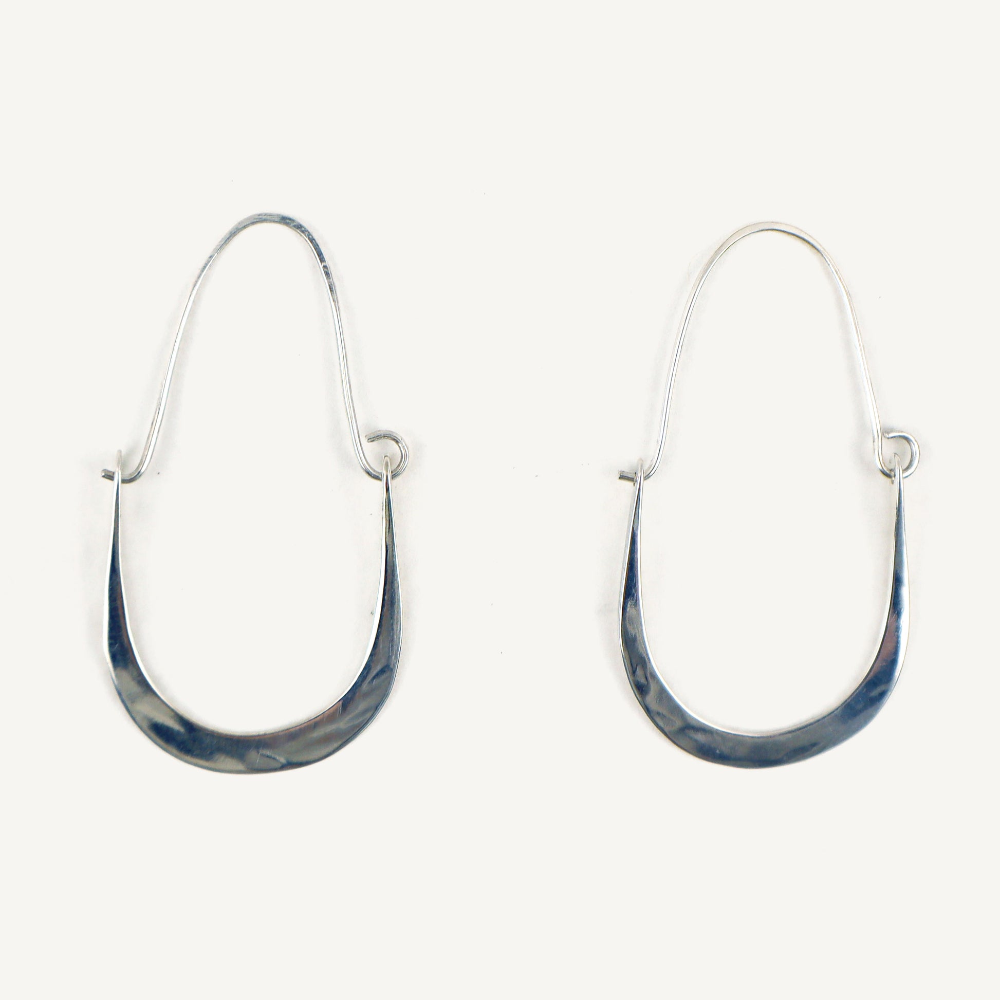Pair of silver hoop earrings with blue marbled finish on a white background