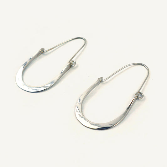 Pair of silver hoop earrings on a white background