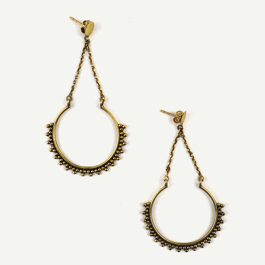 Pair of gold hoop earrings with chain details on a white background