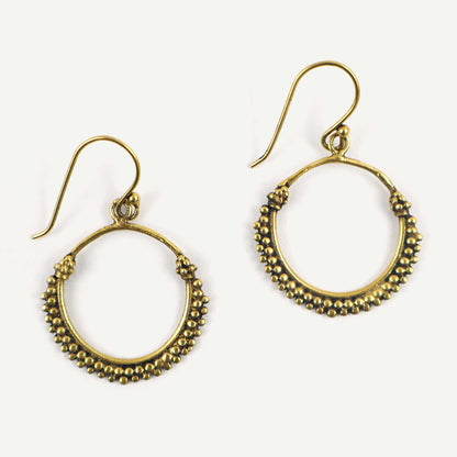 Pair of gold hoop earrings with bead detailing on a white background