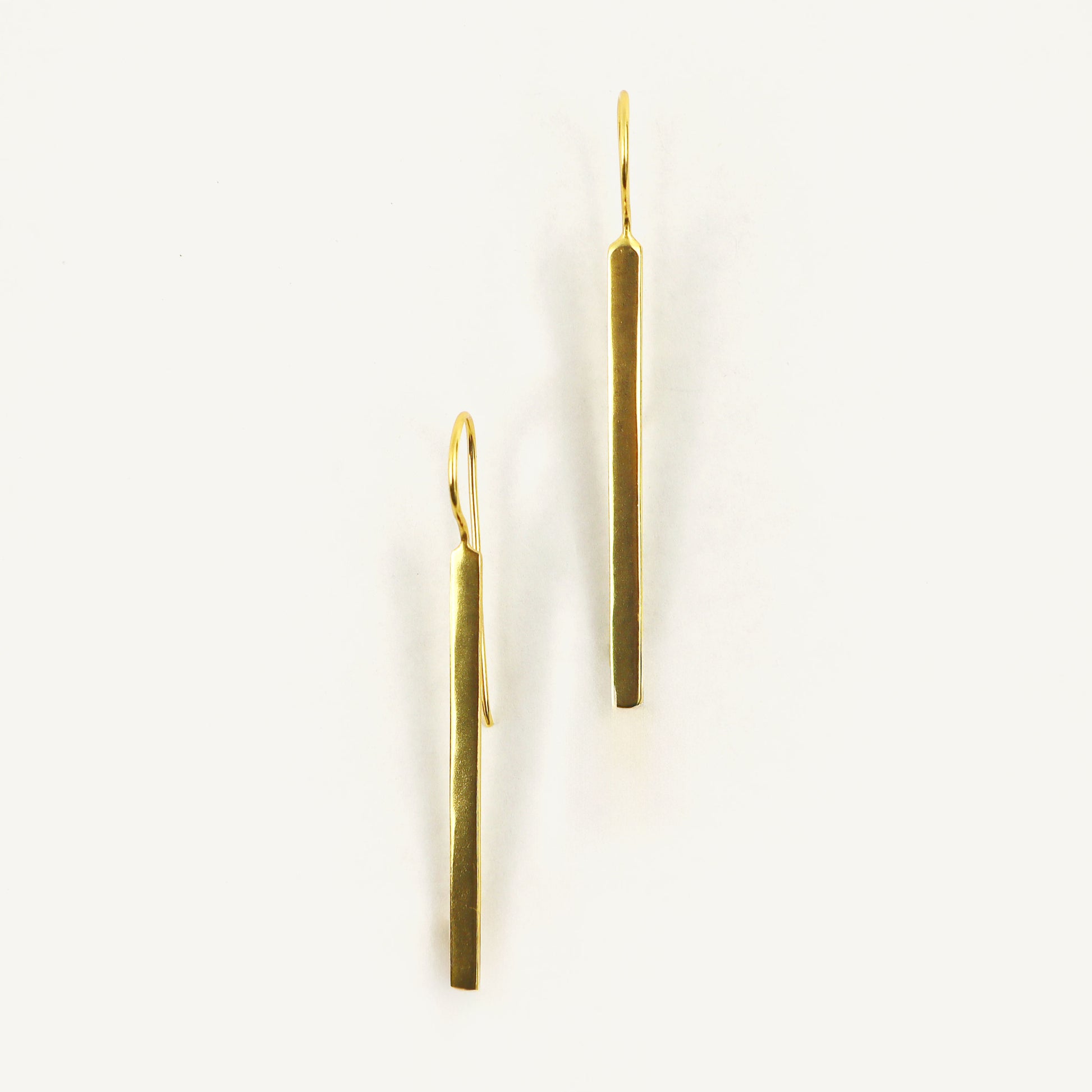 Pair of gold earrings on a white background