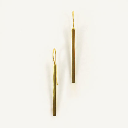 Pair of gold earrings on a white background