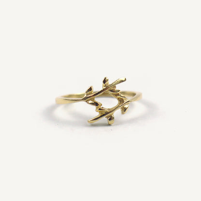 Gold branch-shaped ring on a white background