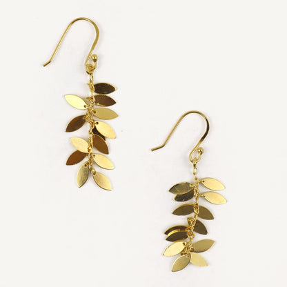 Gold leaf-shaped earrings on a white background