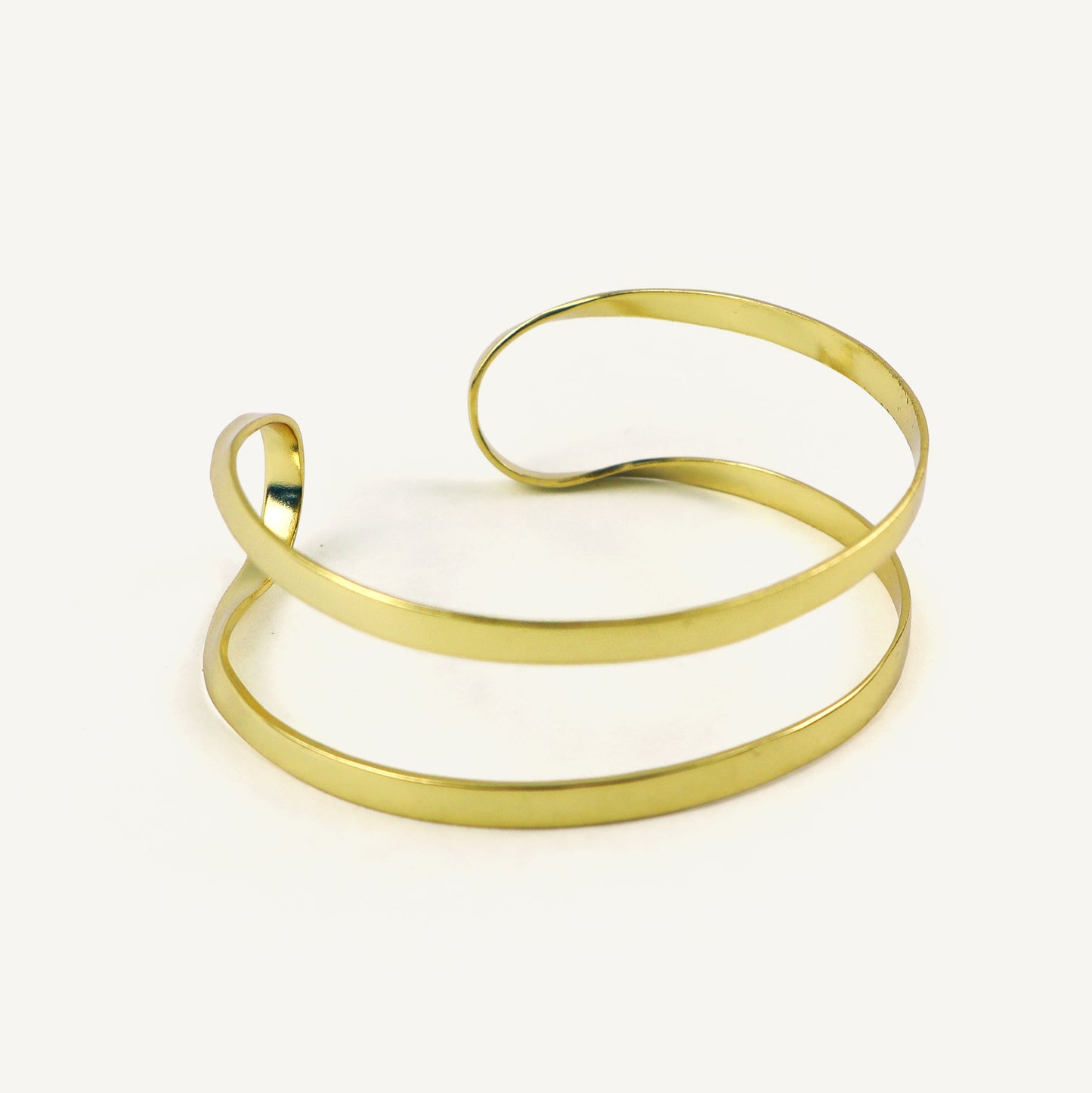 Gold bangle on a white background