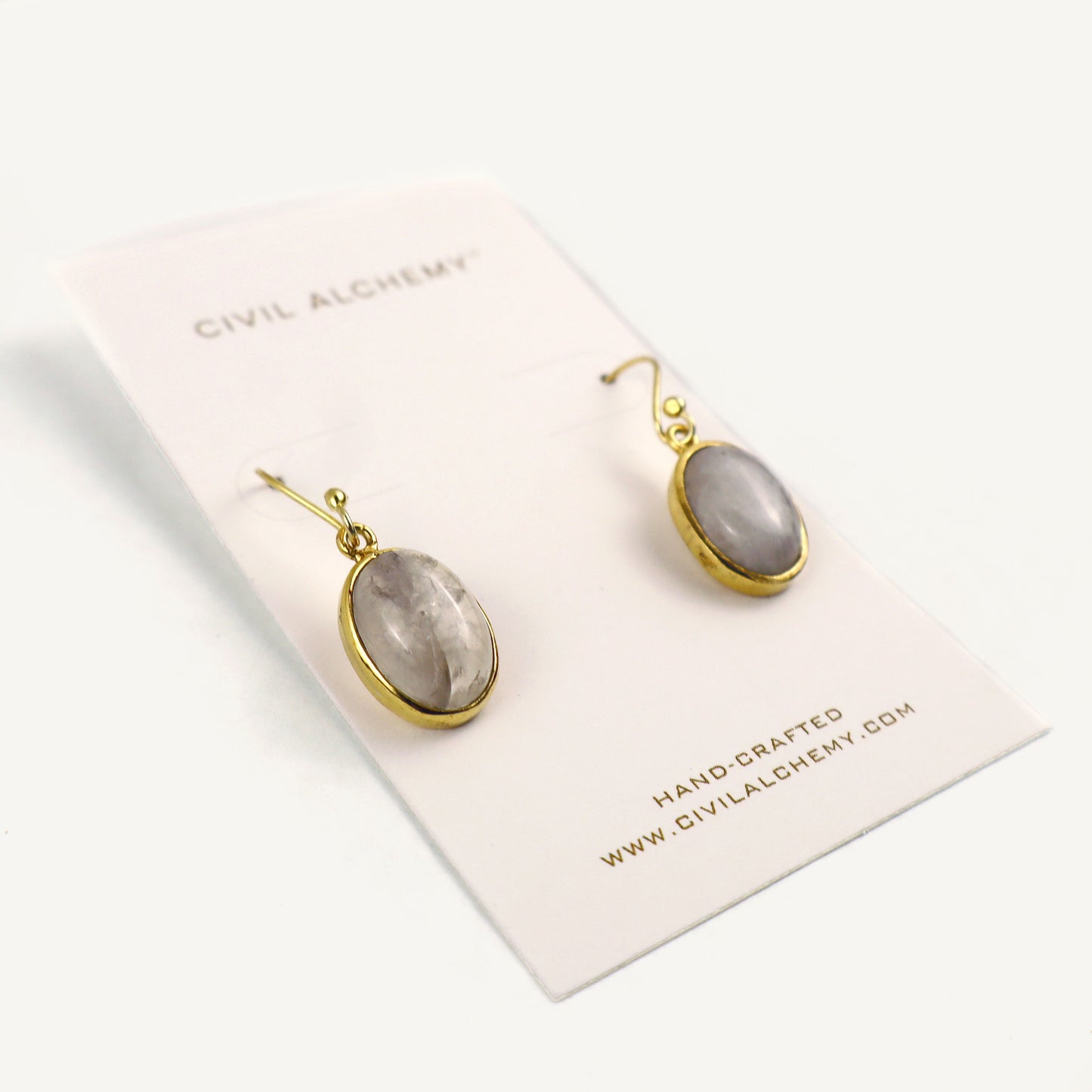 Pair of earrings on a Civil Alchemy branded card with a white background