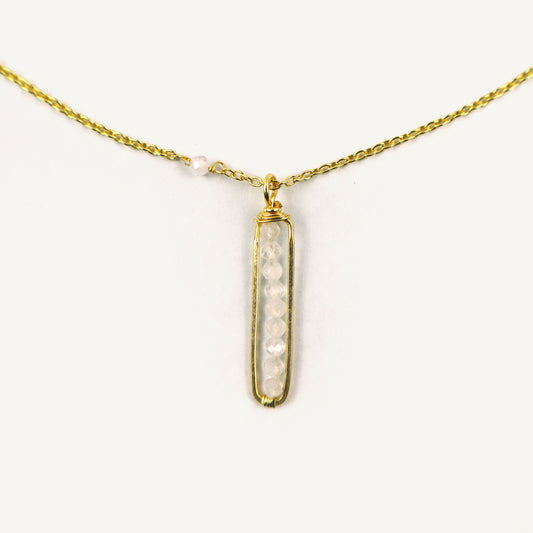Gold necklace with a pendant on a white background