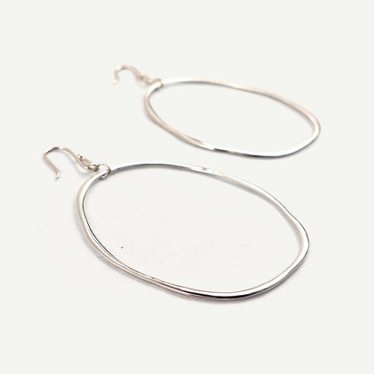Pair of silver hoop earrings on a white background