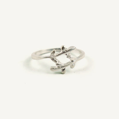 Silver ring with a leaf design on a white background