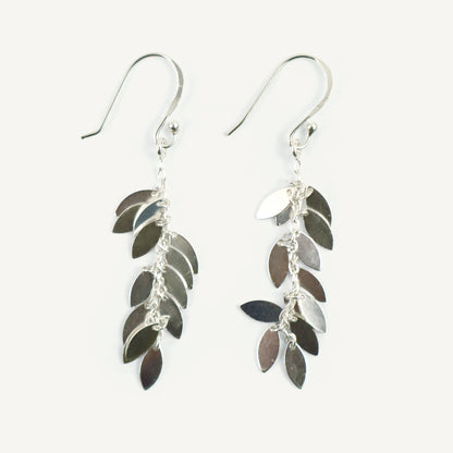 Silver leaf-shaped earrings on a white background