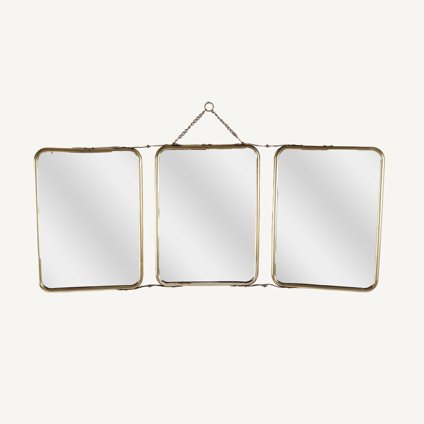 A set of three folding brass mirrors with gold frames, displayed in a triangular formation, with the mirrors showing reflections.