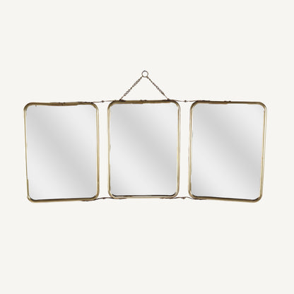 A set of three folding brass mirrors with gold frames, displayed in a triangular formation, with the mirrors showing reflections.