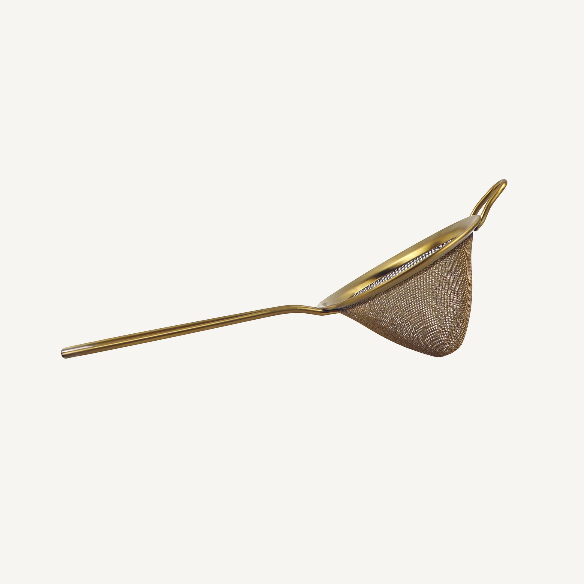Gold-colored mesh strainer on a white background