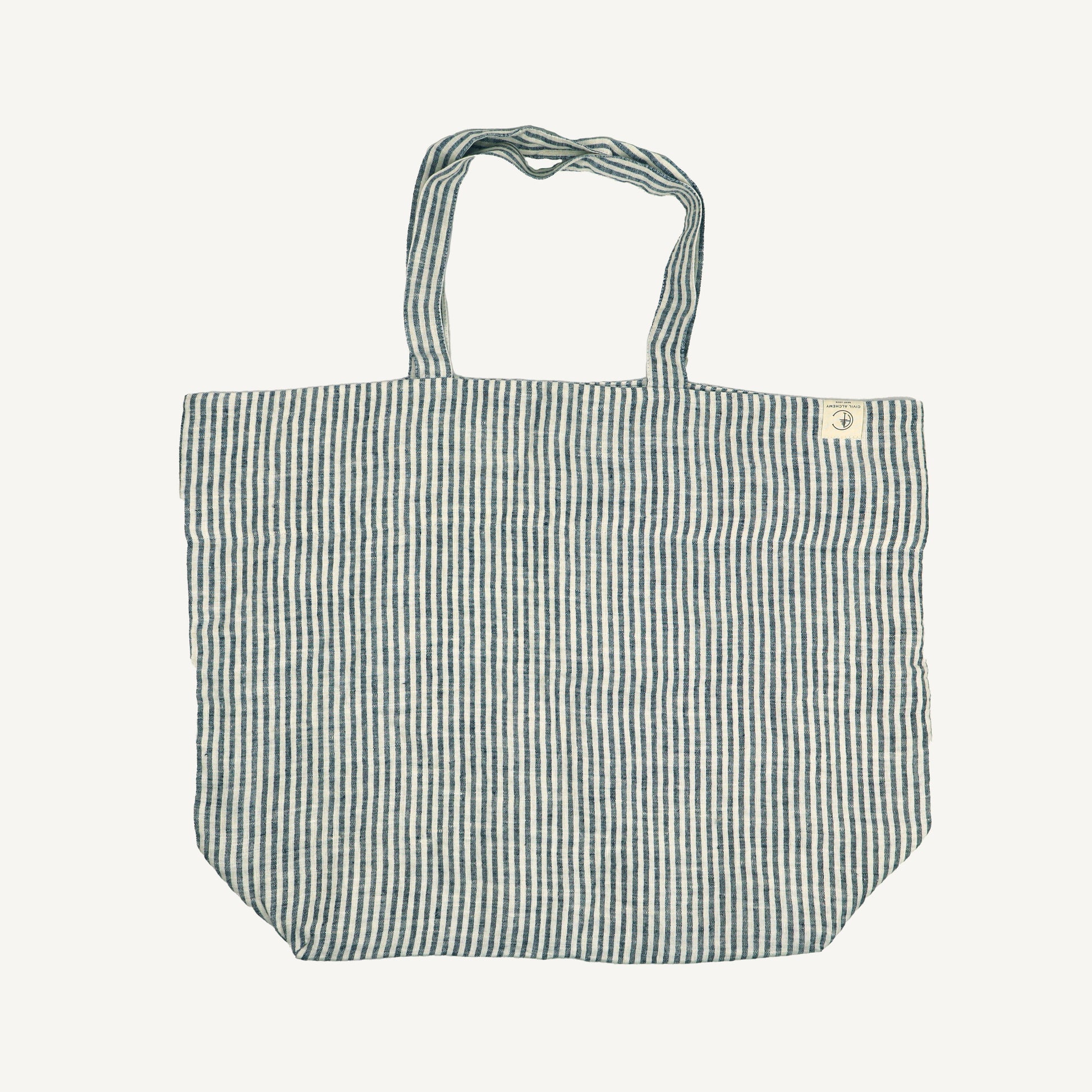 A striped linen tote bag with handles, displayed against a white background.