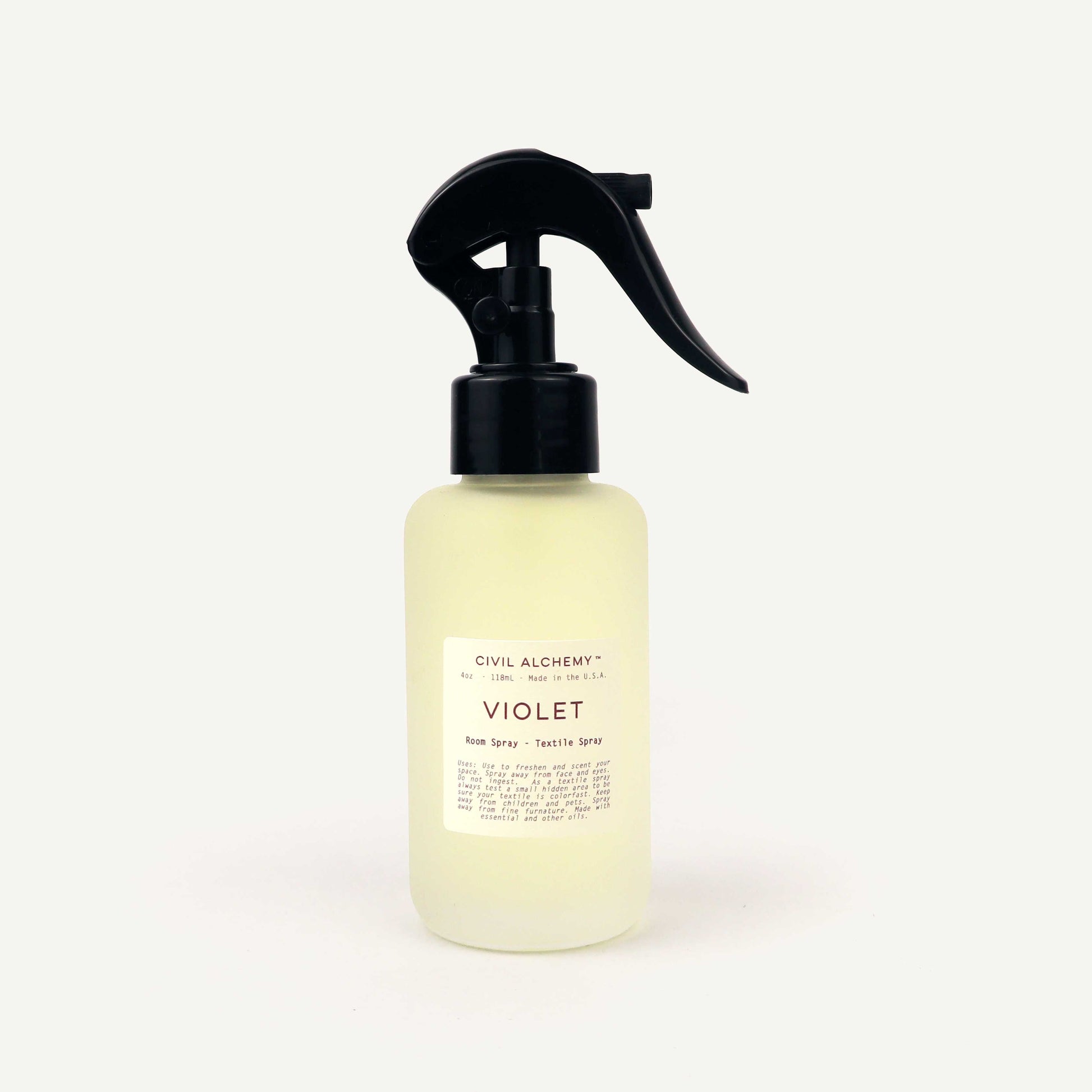 Bottle of Civil Alchemy Violet Room Spray on a white background