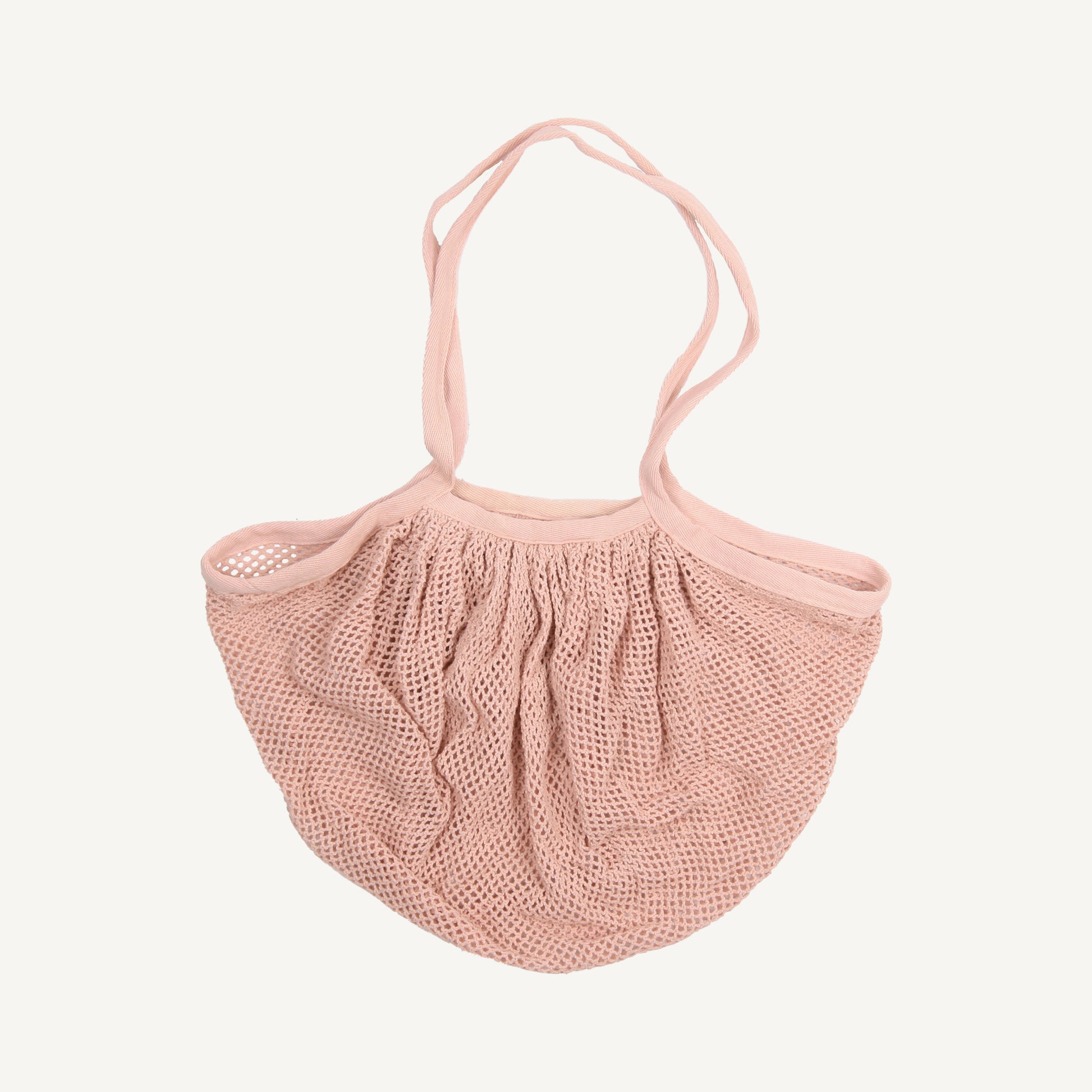 A pink cotton market bag with a fishnet-style design, featuring a handle and a drawstring closure.